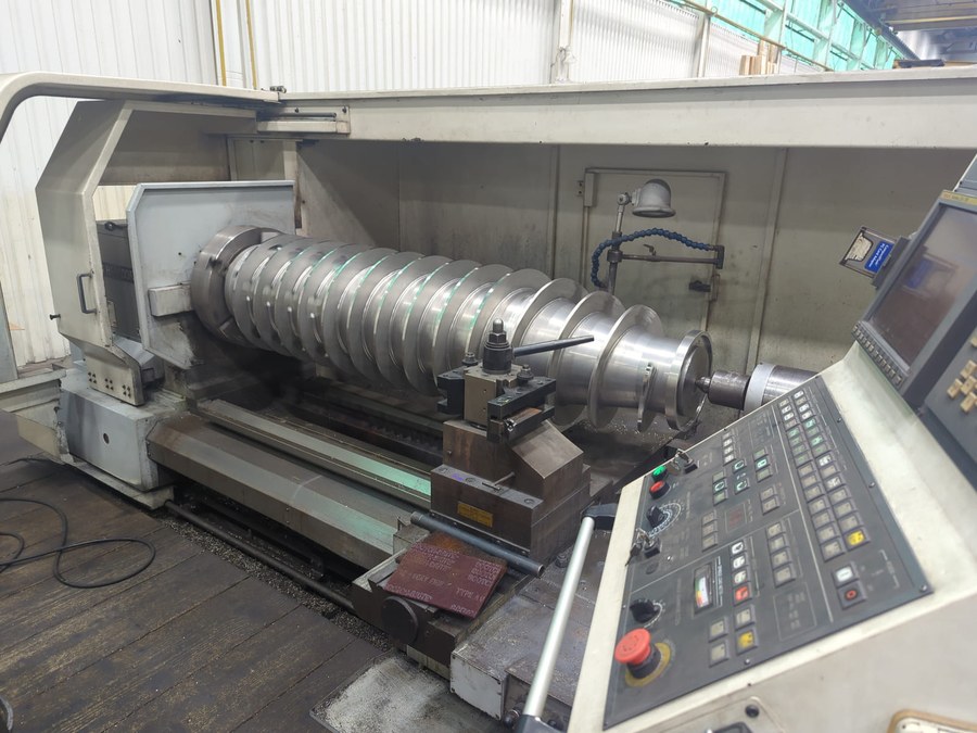 Centrifuge Screw Precision Machining | HFW Industries Precision machining of a centrifuge screw in a lathe for chemical processing equipment at HFW Industries