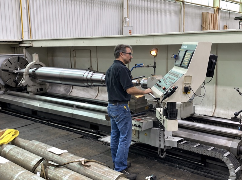 Lathe Machining Large Shaft for Oil & Gas | HFW Industries Lathe machining a large industrial shaft for oil and gas equipment at HFW Industries